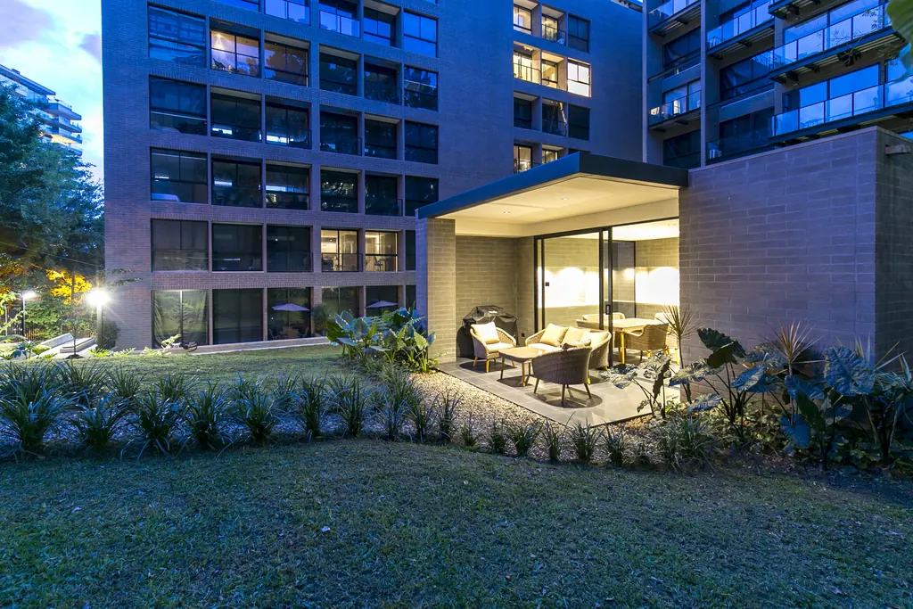 Loma Verde furnished apartments building and green areas at dusk in El Poblado, Medellín
