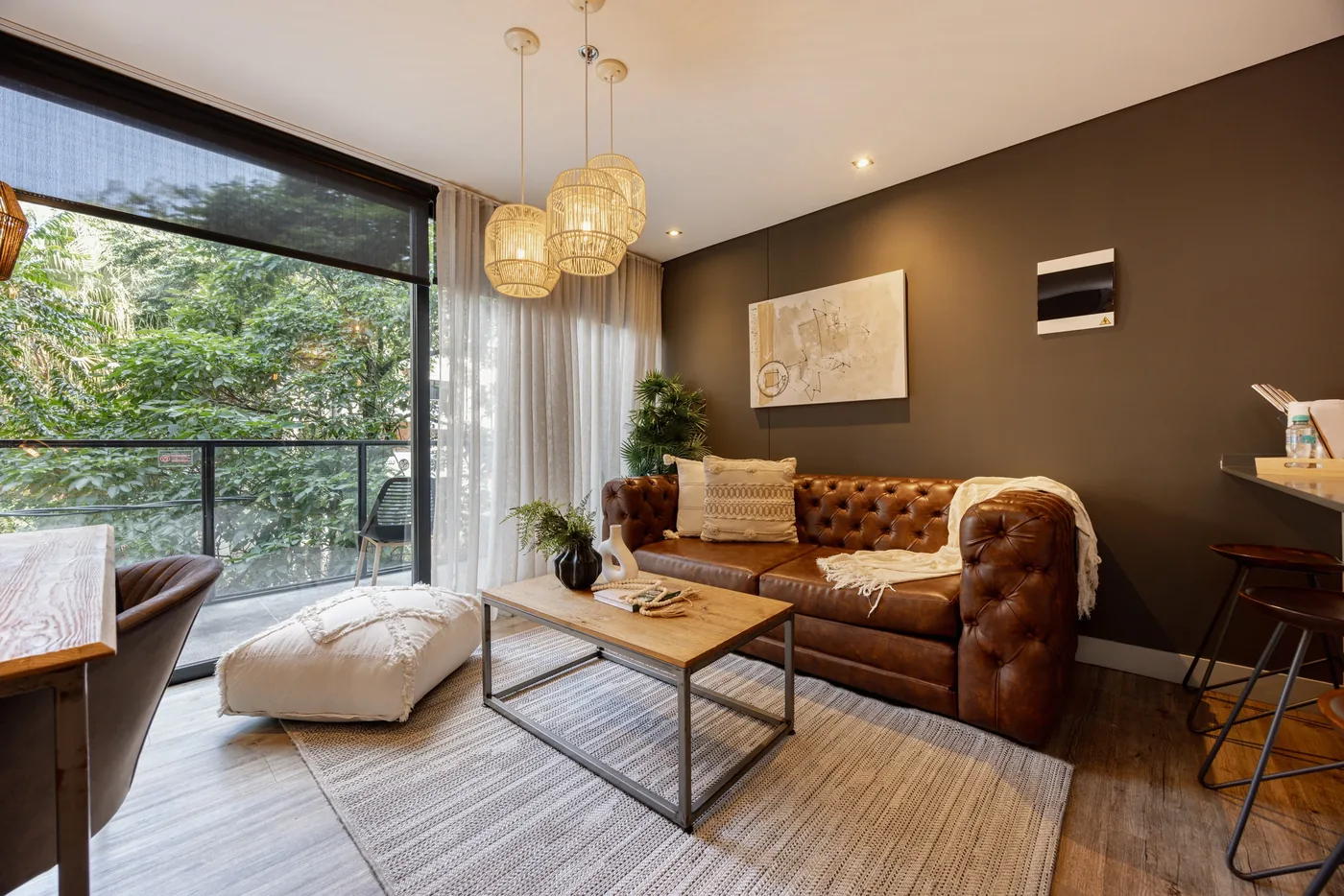 Living room with balcony and garden views in a one-bedroom furnished apartment at Loma Verde, Medellín
