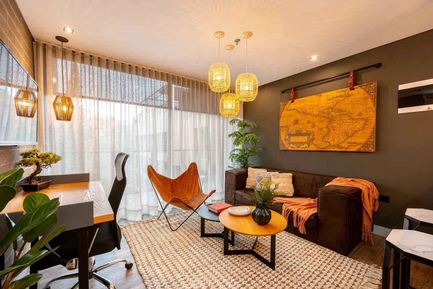 Living room with a workspace in a one-bedroom furnished apartment at Loma Verde, Medellín