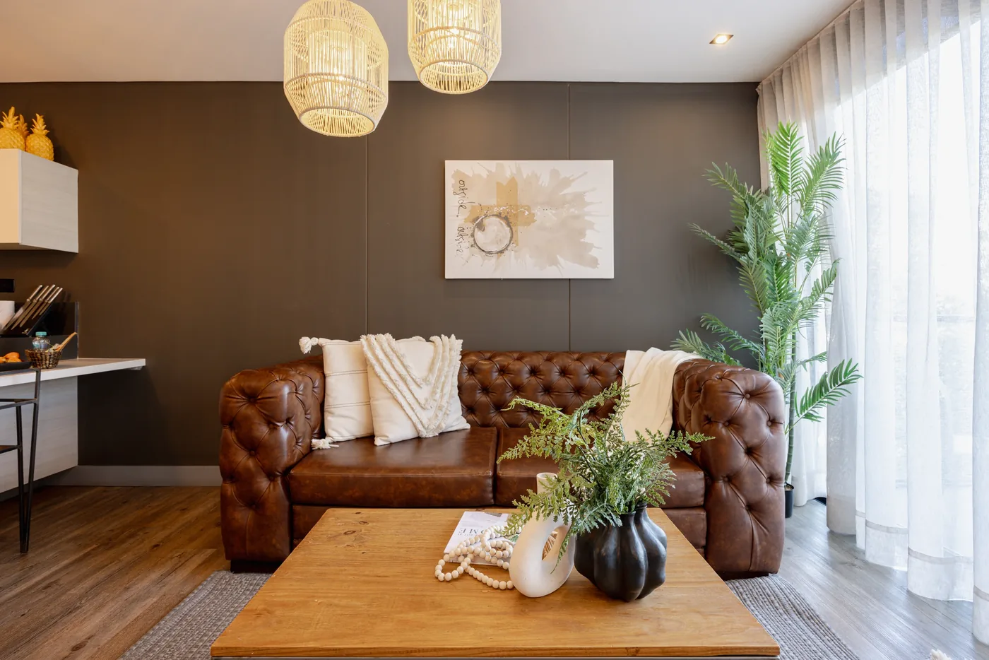 Living room with leather sofa in a two-bedroom furnished apartment at Loma Verde, Medellín
