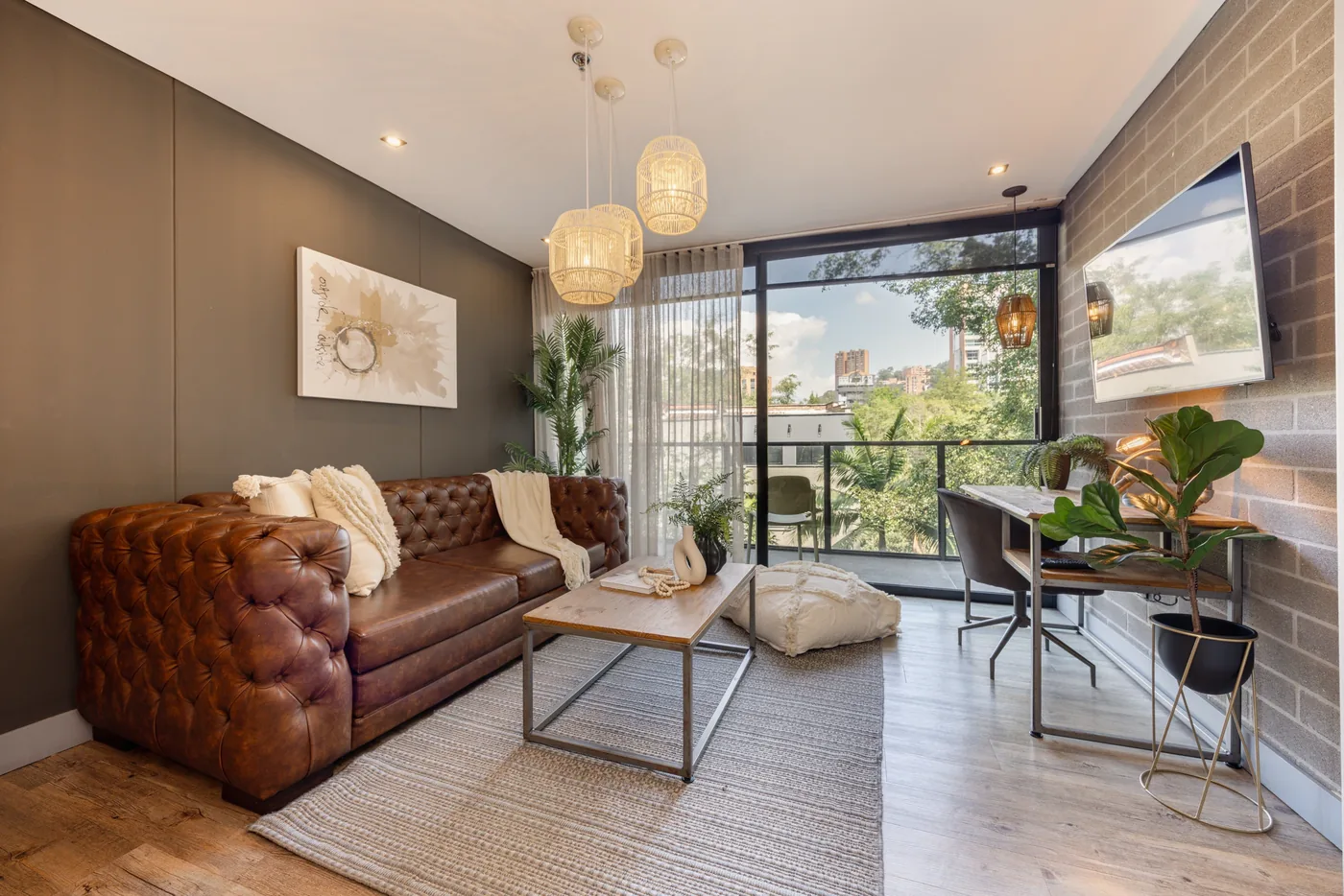 Living room with balcony in a two-bedroom furnished apartment at Loma Verde, Medellín