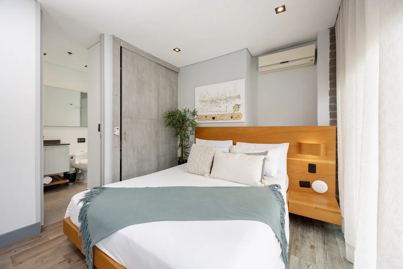 Bedroom with en-suite bathroom in a two-bedroom furnished apartment at Loma Verde, Medellín