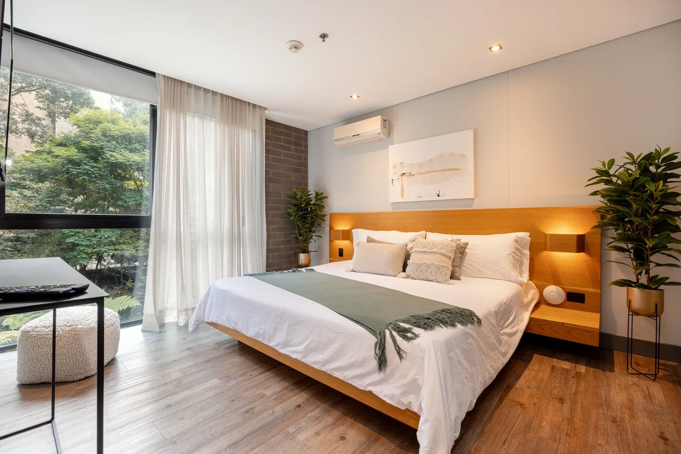Bedroom with balcony doors in a one-bedroom furnished apartment at Loma Verde, Medellín