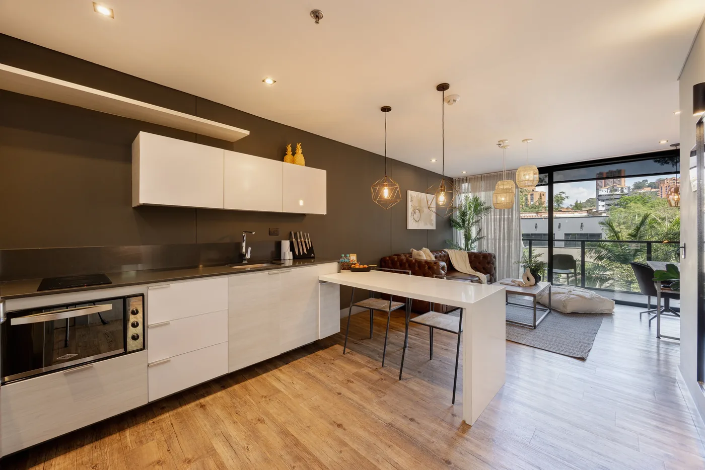Open kitchen and dining area in a two-bedroom furnished apartment at Loma Verde, Medellín