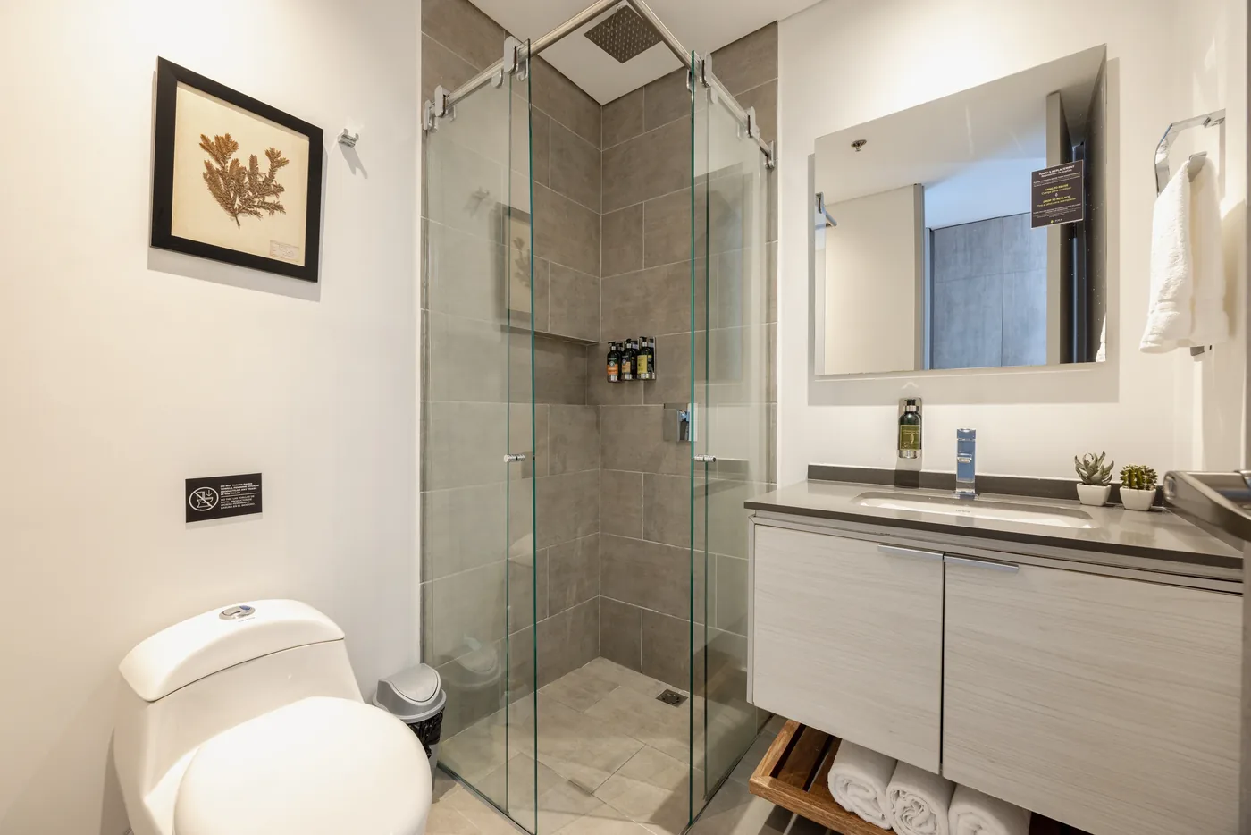 Bathroom with glass shower in a two-bedroom furnished apartment at Loma Verde, Medellín